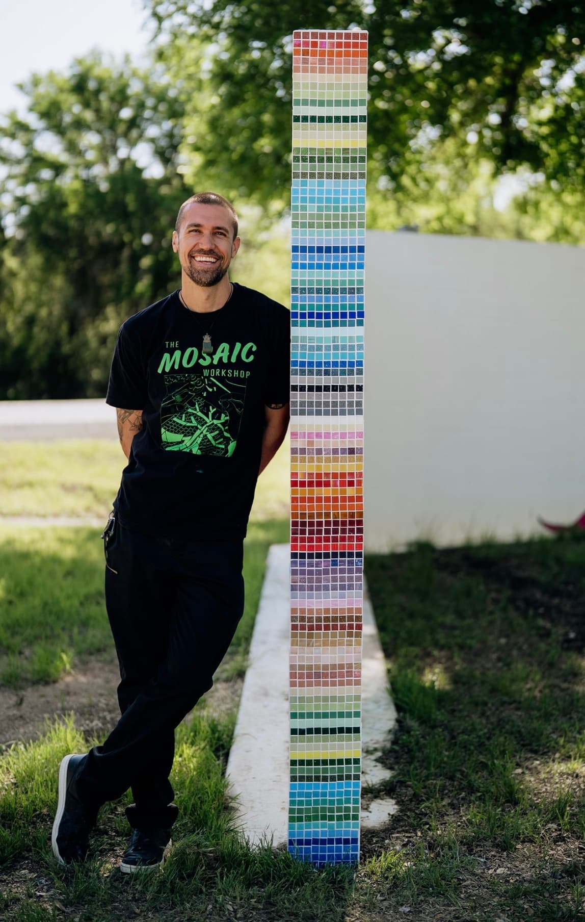 J Muzacz in front of mosaic artwork
