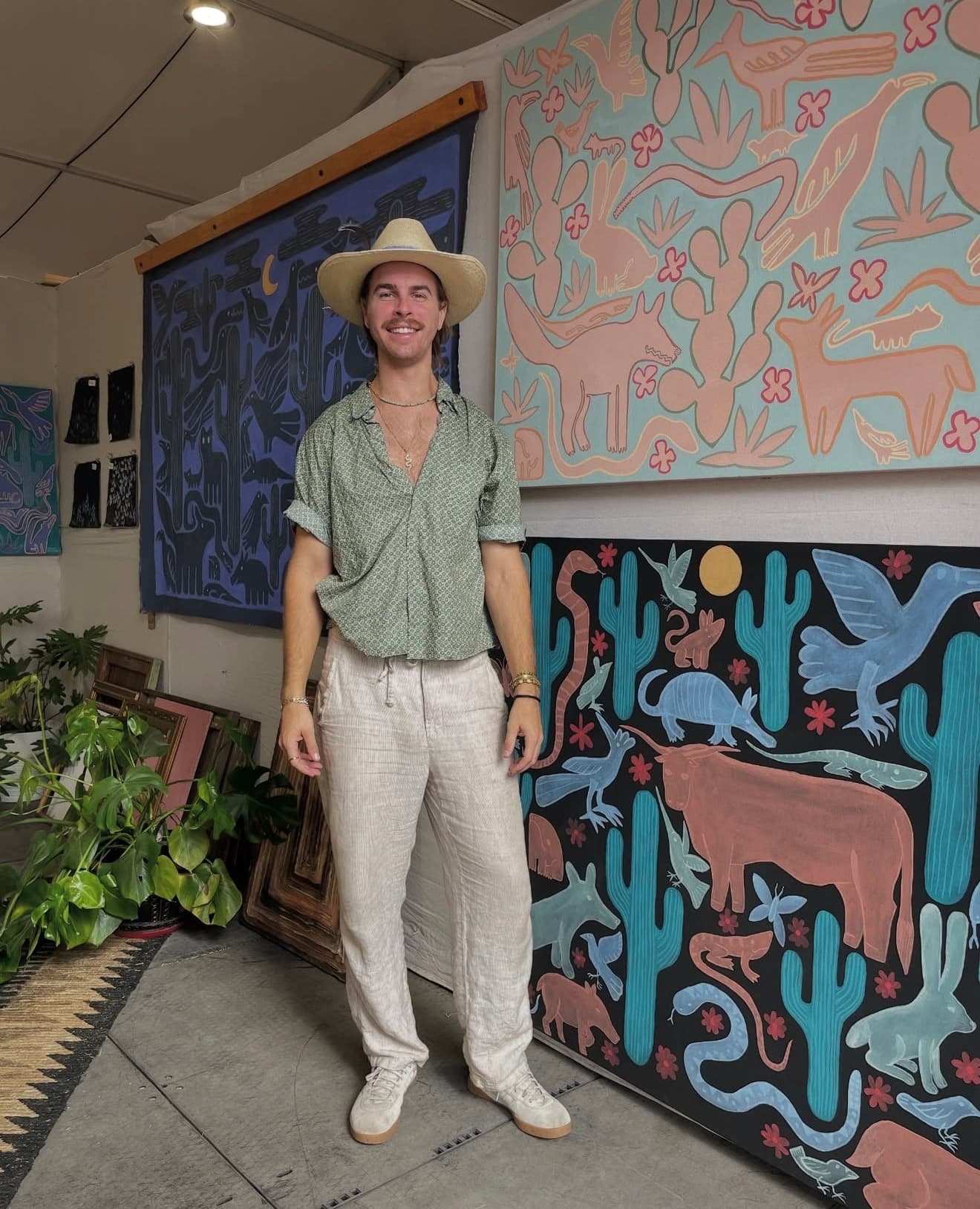 Artist Dan trelenberg in front of his paintingd