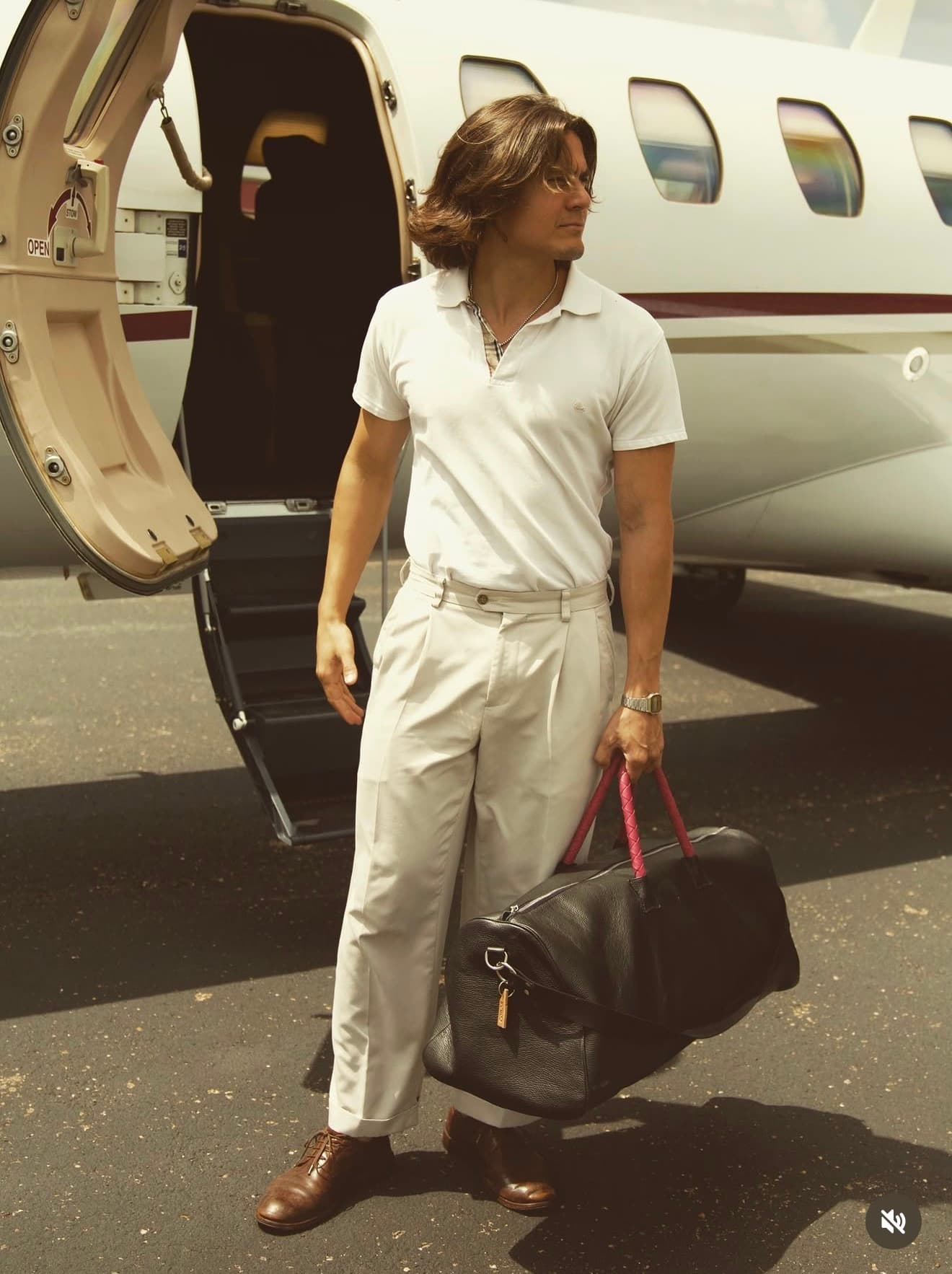 texas leather goods designer Salvador Cobos in front of a small aircraft