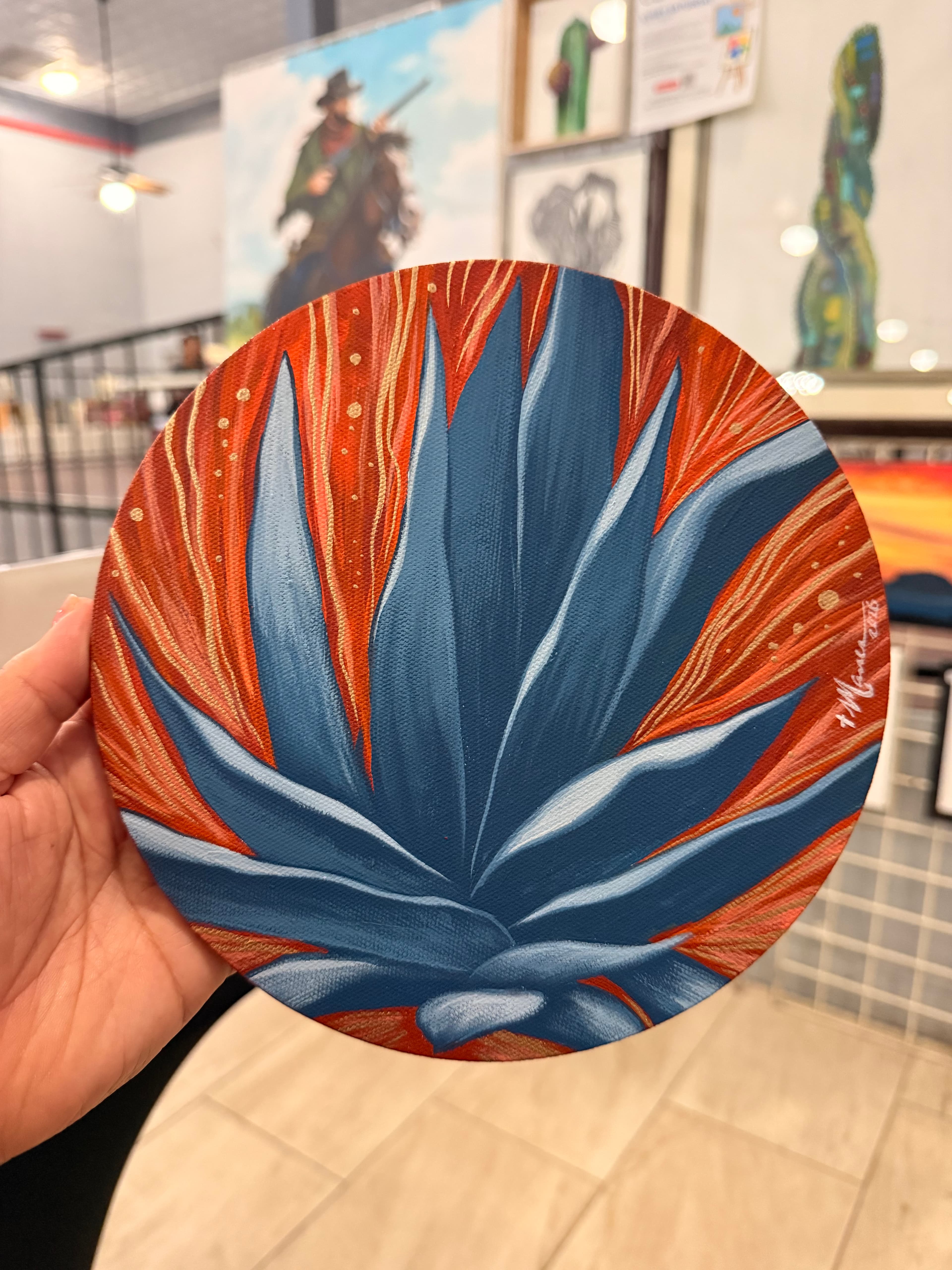 A painting of an agave on an orange background