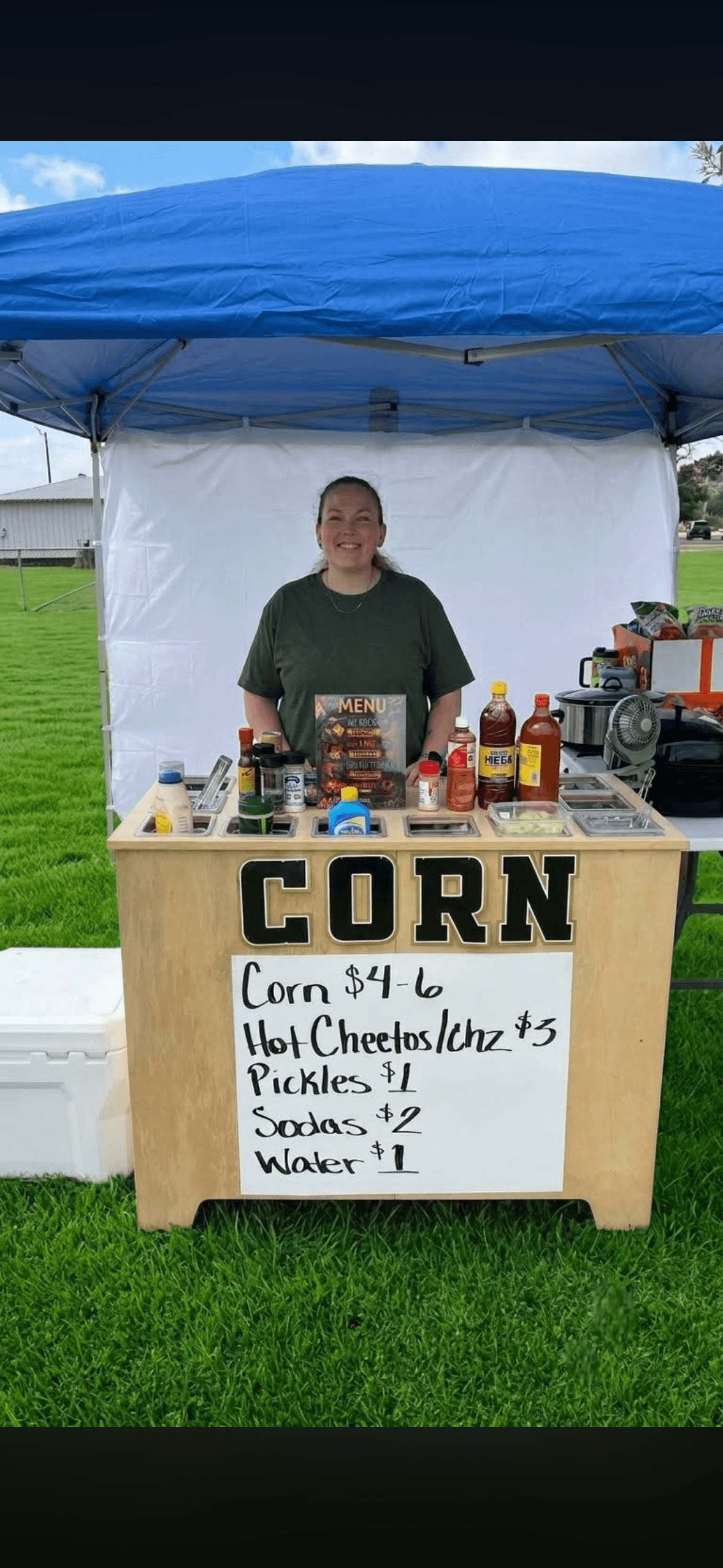 An image of a person selling corn in.a cup