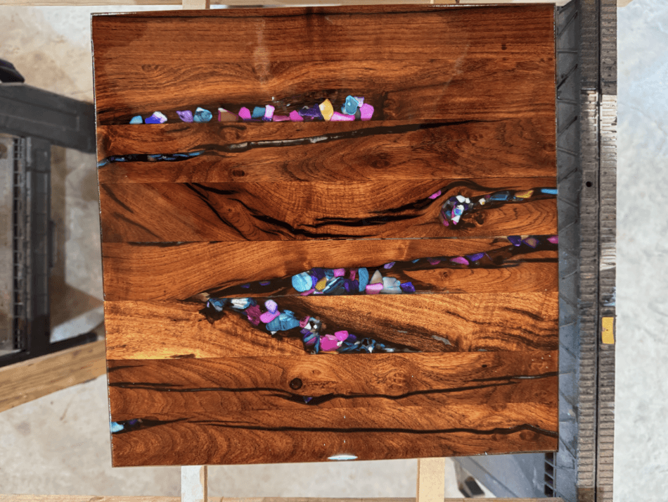 A cuttingboard made by steve with colorful resin inset in the design